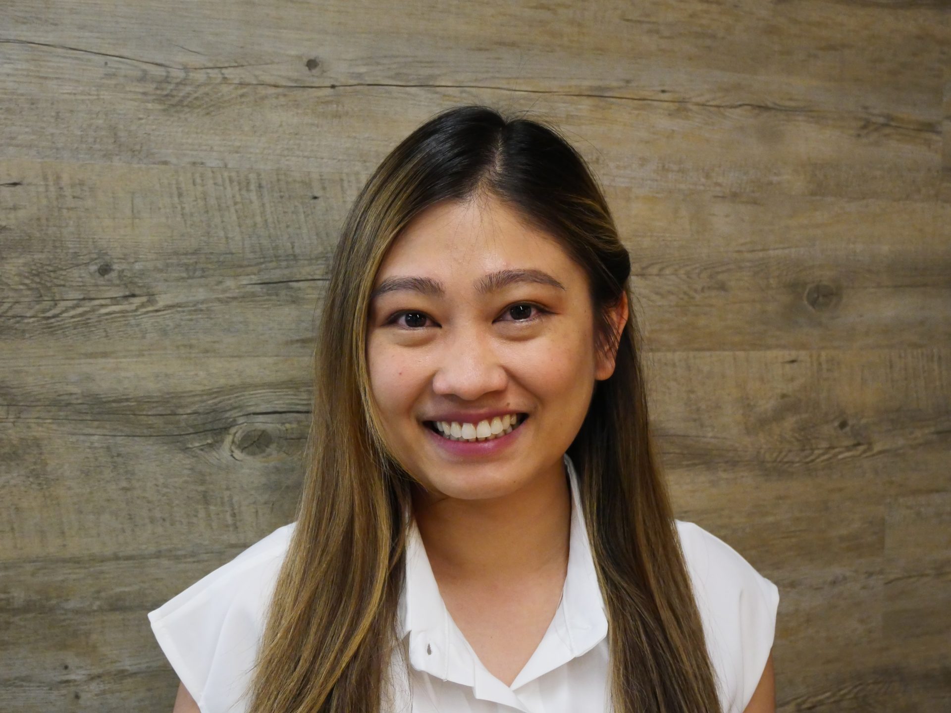 Profile photo of a smiling woman in a white blouse