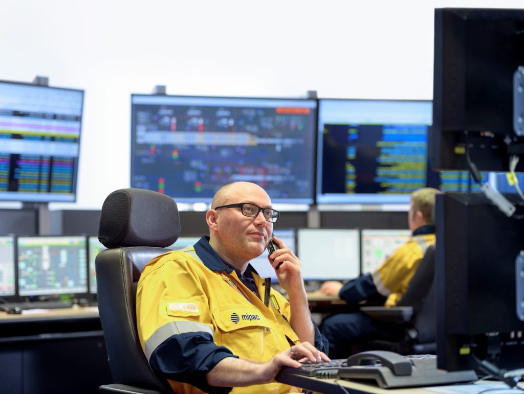 man using computer in control room