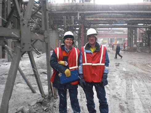 Two men standing on site in snow