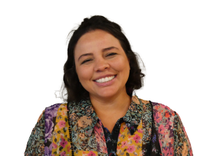 Dark haired woman wearing colourful blouse on white background