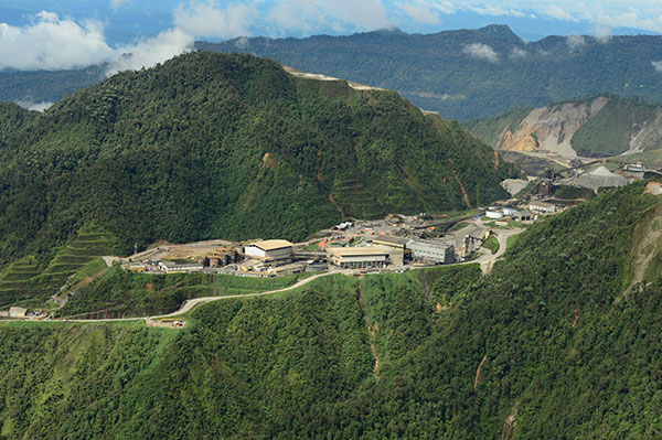 Ok Tedi mine site surrounded by lush green mountains