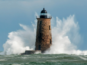 Lighthouse being smashed by waves