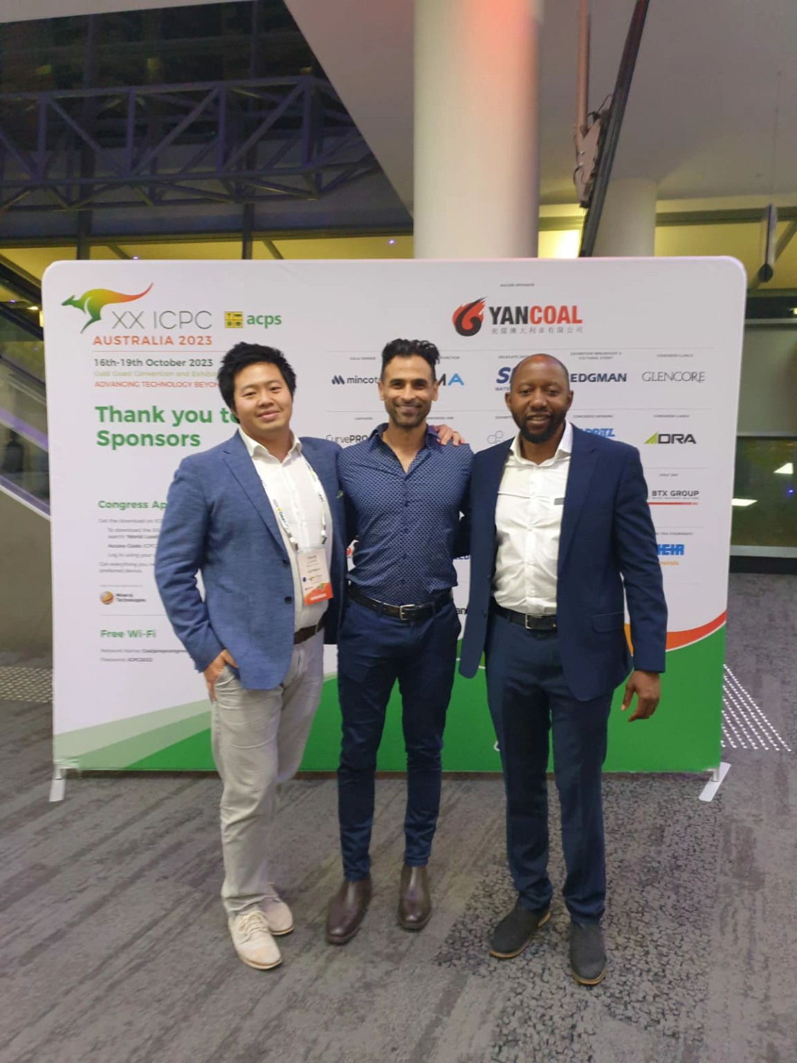 Mipac Senior Process Engineer Hans Liang (first on left, standing beside two other men in front of a branded sign) at the International Coal Preparation Congress (ICPC) on the Gold Coast, where he presented the case study of the Narrabri Coal Loadout Facility Optimisation Project