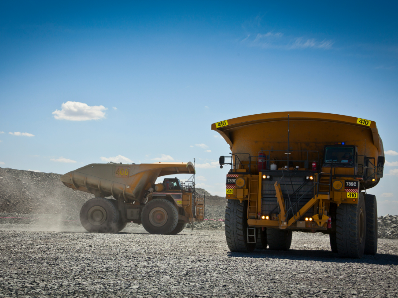 Two mine trucks at Evolution Cowal's underground control system integration project