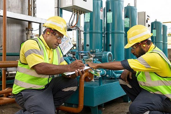 ok tedi case study two men working on site