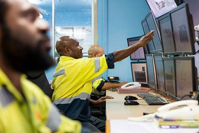 men using computers at ok tedi