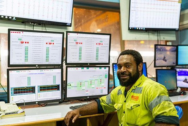 man in front of computers at ok tedi